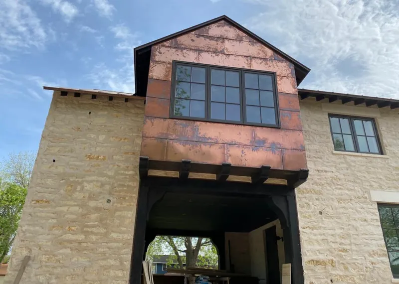 Copper metal panel facade on a stone building for Roof Repair in Gainesville